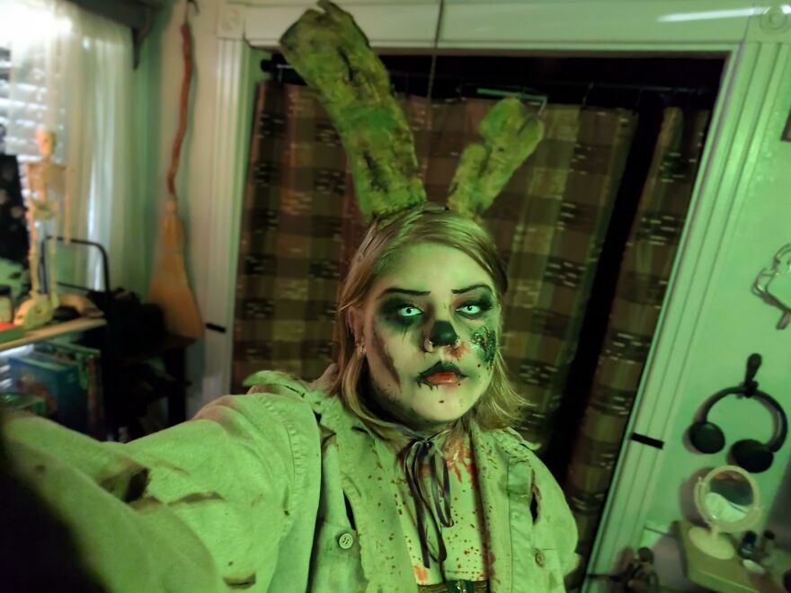 Person wearing spooky makeup and green bunny ears for a creative Halloween costume idea.