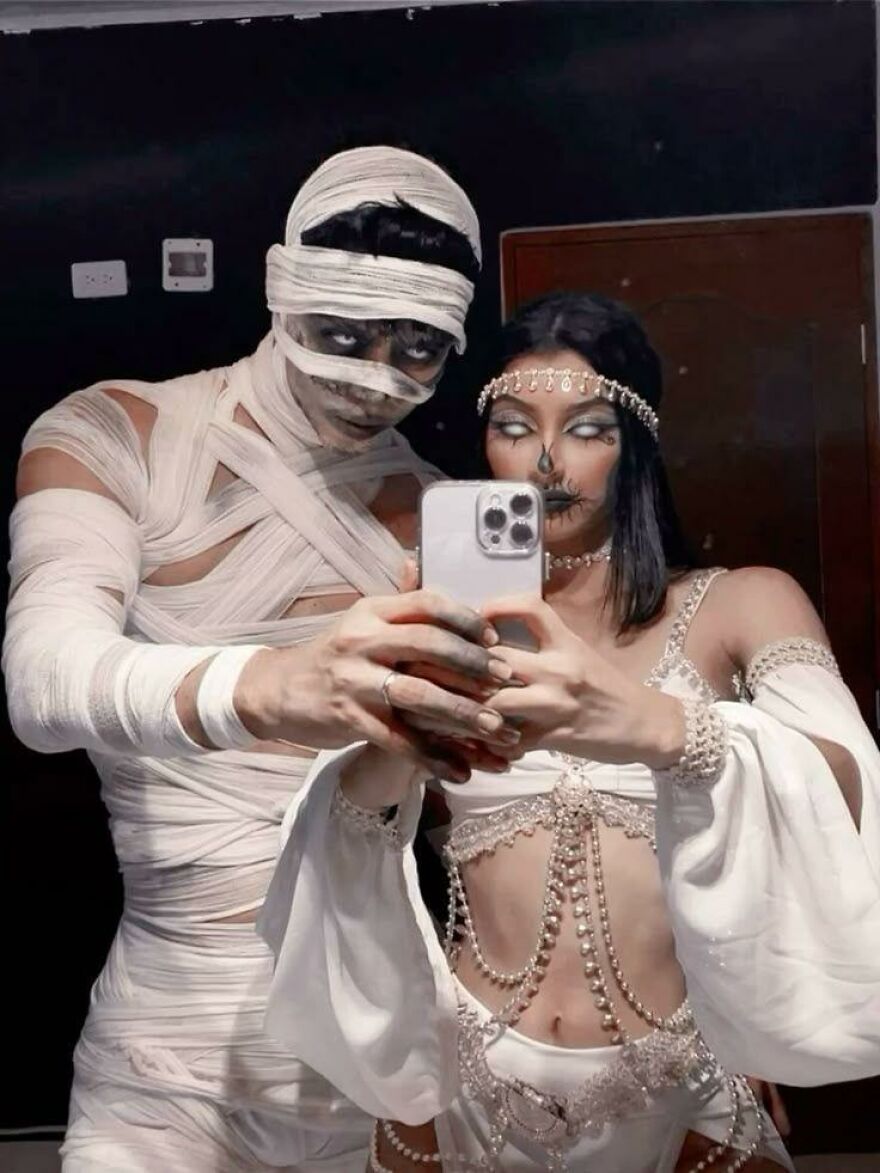 A couple dressed up in detailed mummy attire, sharing creative Halloween costume ideas.