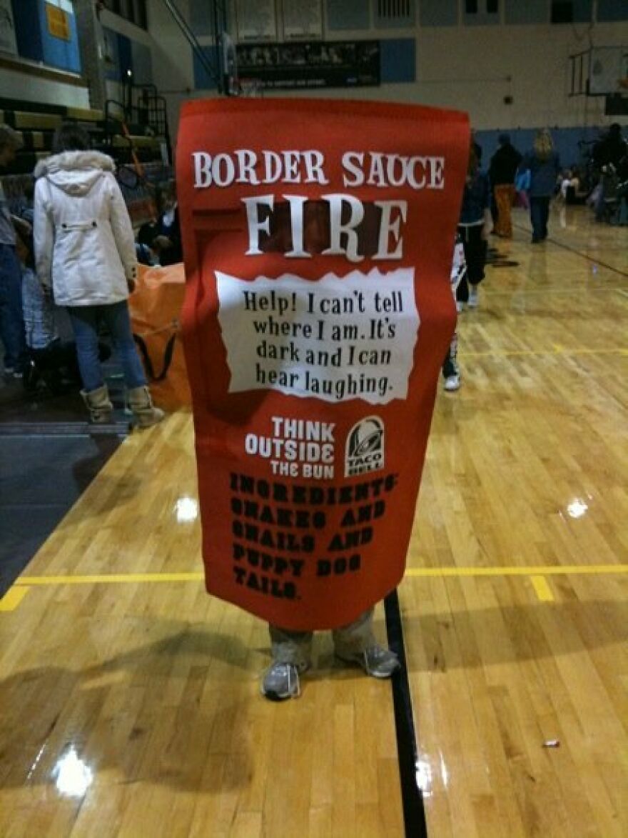 Person wearing a giant hot sauce packet outfit as a creative Halloween costume idea