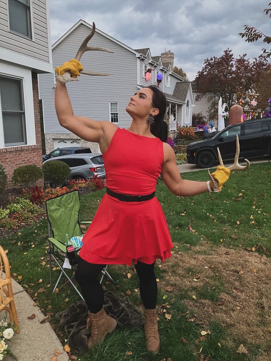 Athletic woman dressed as Gaston showing creative Halloween costume ideas outdoors
