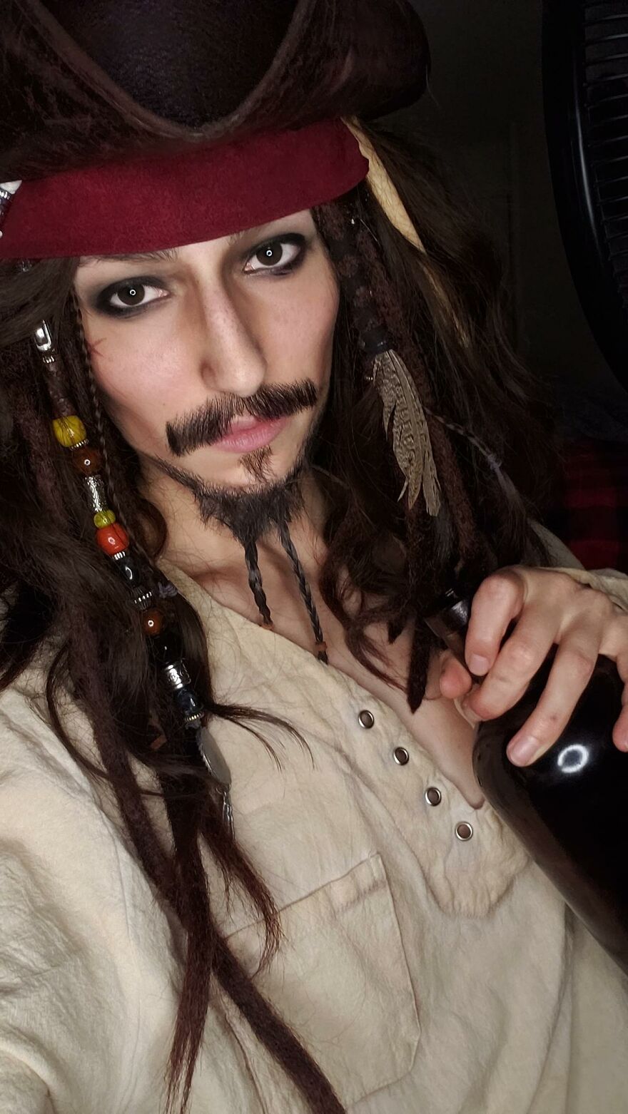 A person in detailed Jack Sparrow makeup and pirate attire, perfect creative Halloween costume ideas.