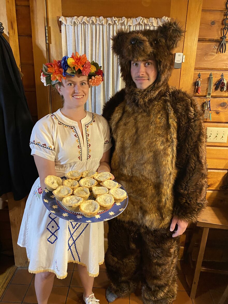 A couple in Midsommar inspired Halloween costume ideas with floral crown and bear suit