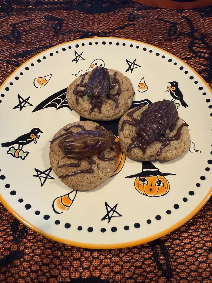 Cockroach shaped Halloween foods made from dates and chocolate on a decorated plate