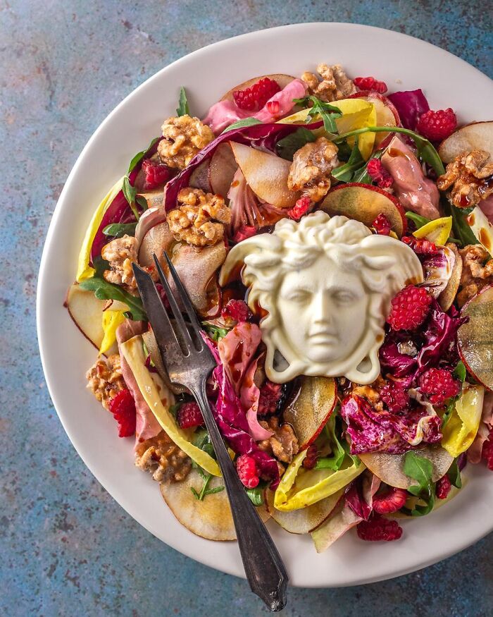 A fresh autumn salad served with a Medusa face center object, representing unique Halloween foods.