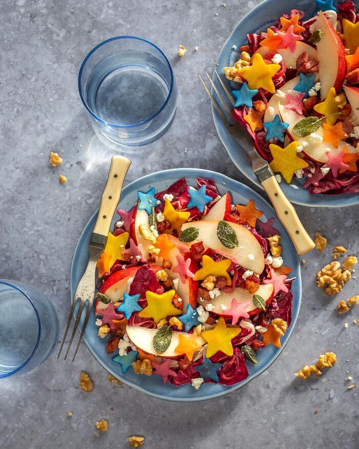 Colorful salad topped with star-shaped vegetables as festive Halloween foods.