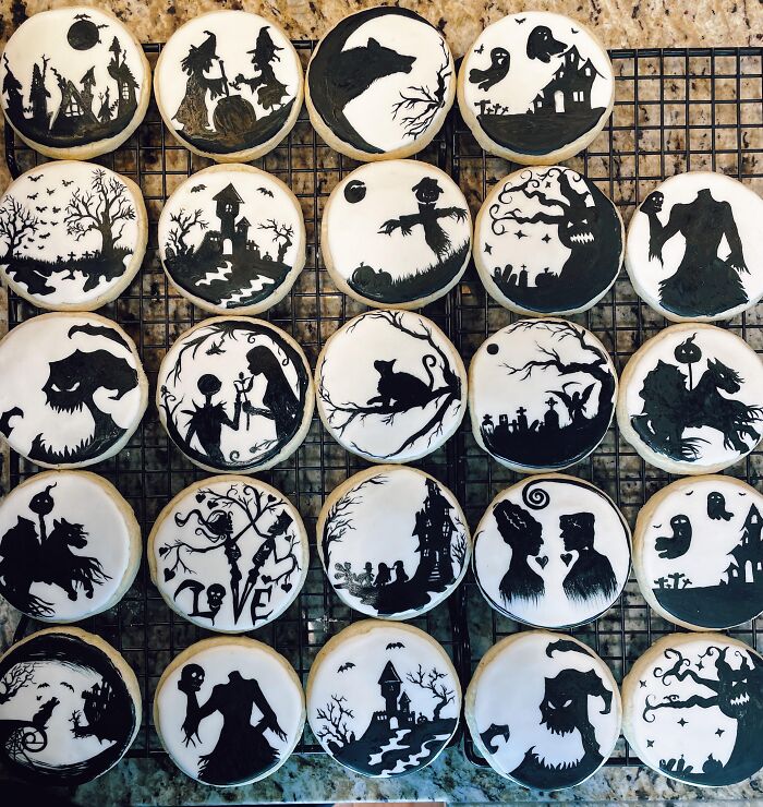 A grid of monochrome sugar cookies decorated with spooky silhouettes as creative Halloween foods.