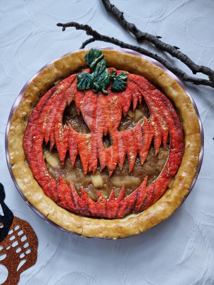 Homemade pie with a scary jack-o-lantern face crust as spooky Halloween foods