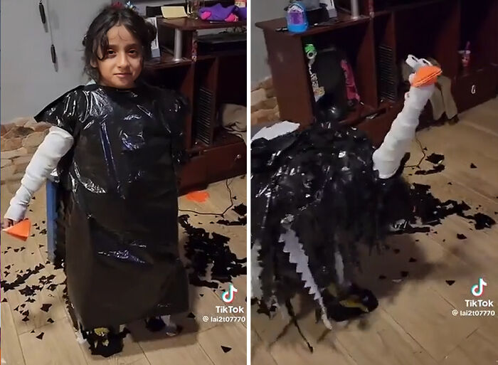 A young girl wearing a unique handmade black bird Halloween costume with an orange beak indoors.