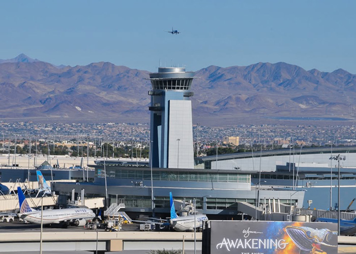 An airport control tower overlooking grounded planes before a United Flight takeoff. An airport control tower overlooking grounded planes before a United Flight takeoff.