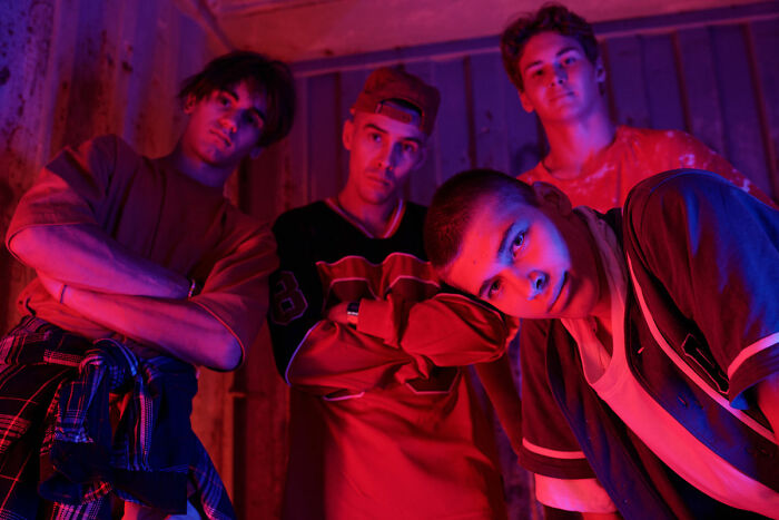 Group of young men in dramatic lighting for funny haunted house stories