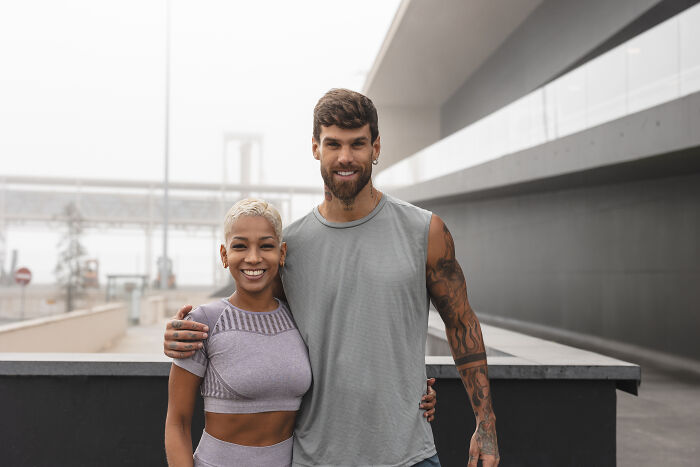Couple smiling outdoors in casual wear for funny haunted house stories