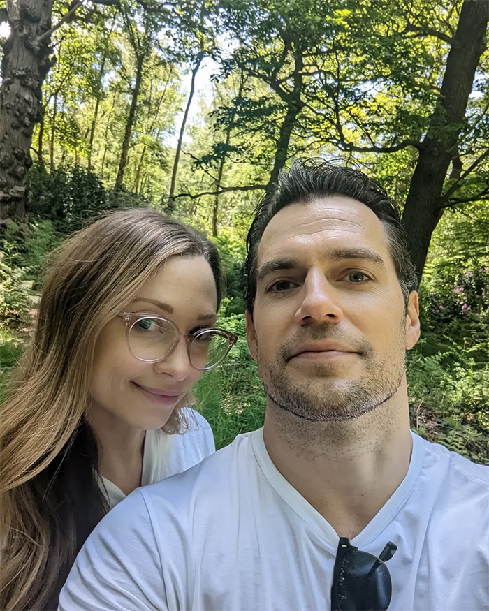 Henry Cavill posing outdoors with his partner, showing Henry Cavill's Five-Year Transformation.