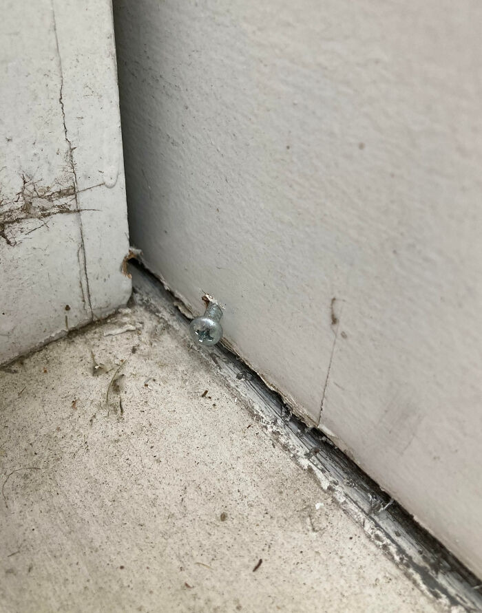 A s***w placed poorly in a corner baseboard during a rushed home renovation project