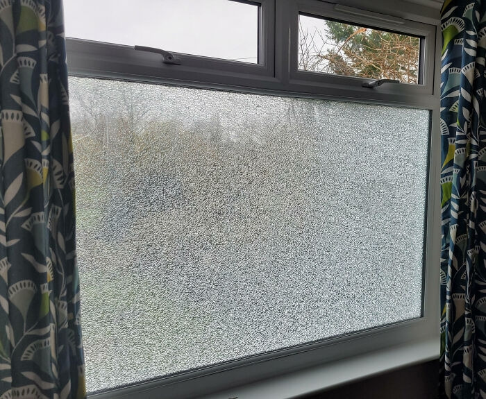 A shattered window pane demonstrating a home renovation gone wrong.