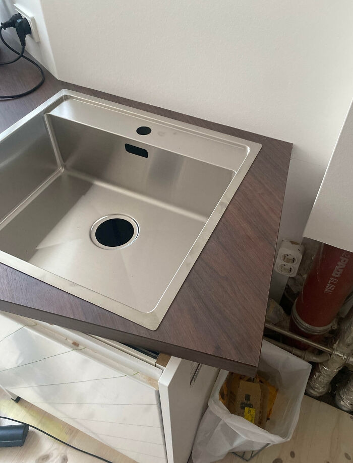 An awkwardly fitted kitchen sink showing a home improvement layout fiasco.
