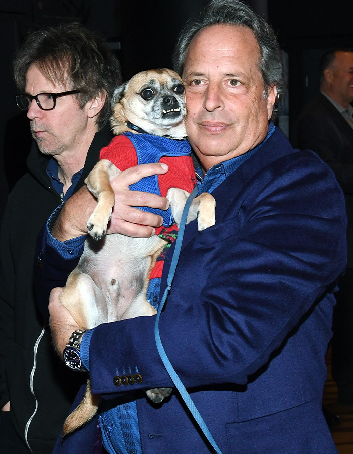 Jon Lovitz holding a small dog alongside Dana Carvey. Jon Lovitz holding a small dog alongside Dana Carvey.