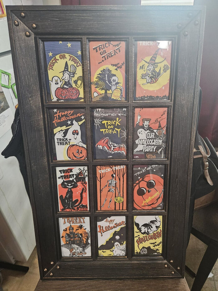 Framed vintage Halloween cards and trick or treat art display on a wall