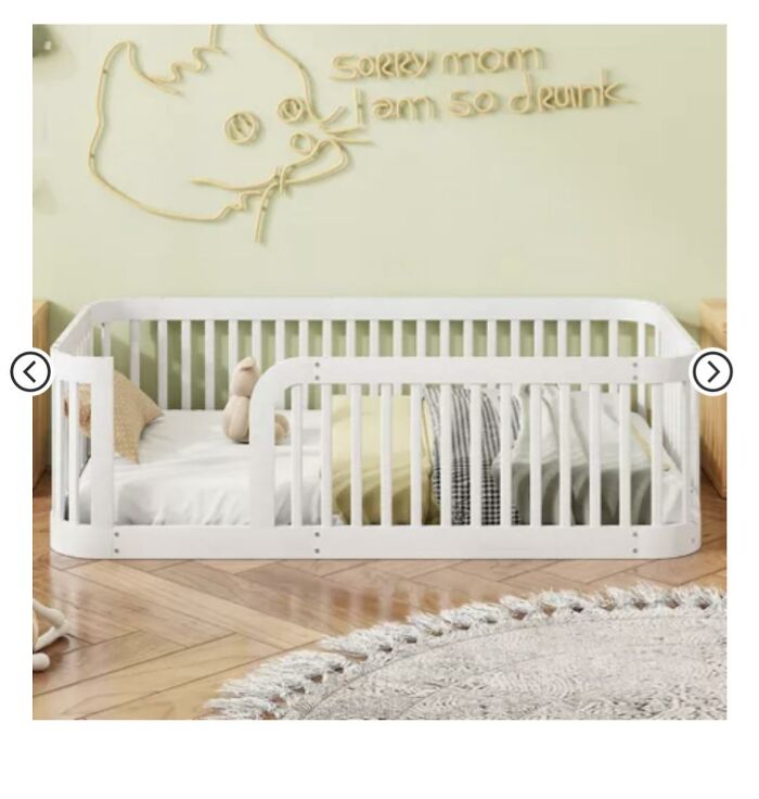 White toddler bed in a room with a decorative sign on the wall reading a funny inappropriate message.