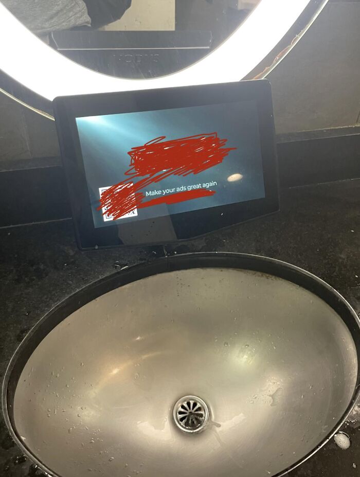 A bathroom sink with an ad display screen, showcasing one of many absurd products.