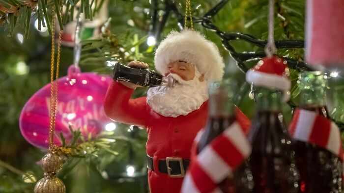 Santa Claus ornament drinking soda on a Christmas tree, illustrating iconic marketing and PR stunts.