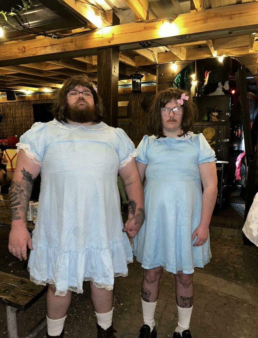 Two bearded men dressed as the Shining twins for a funny creative Halloween costume idea.