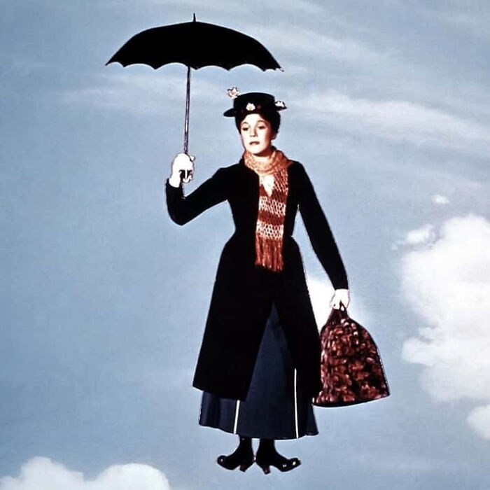 Mary Poppins floating in the air with her umbrella and bag, iconic movie props
