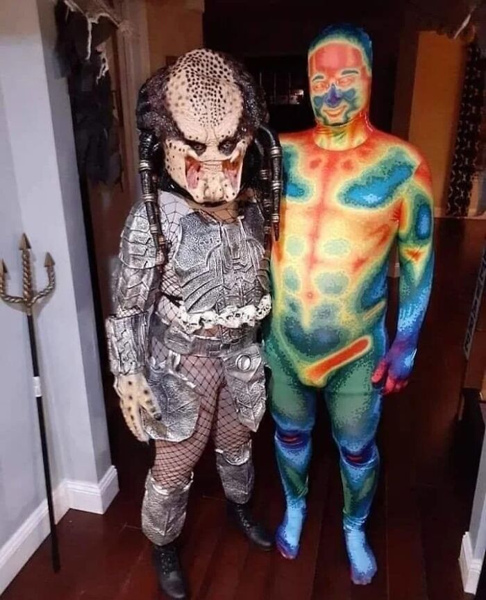 Creative Halloween couples costume featuring the Predator standing alongside a thermal vision heat map figure