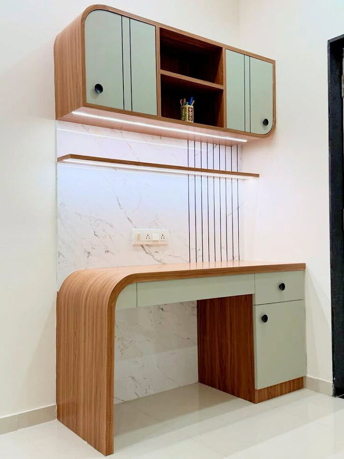 Modern office furniture featuring wooden creations with a sleek curved desk and pastel cabinets.