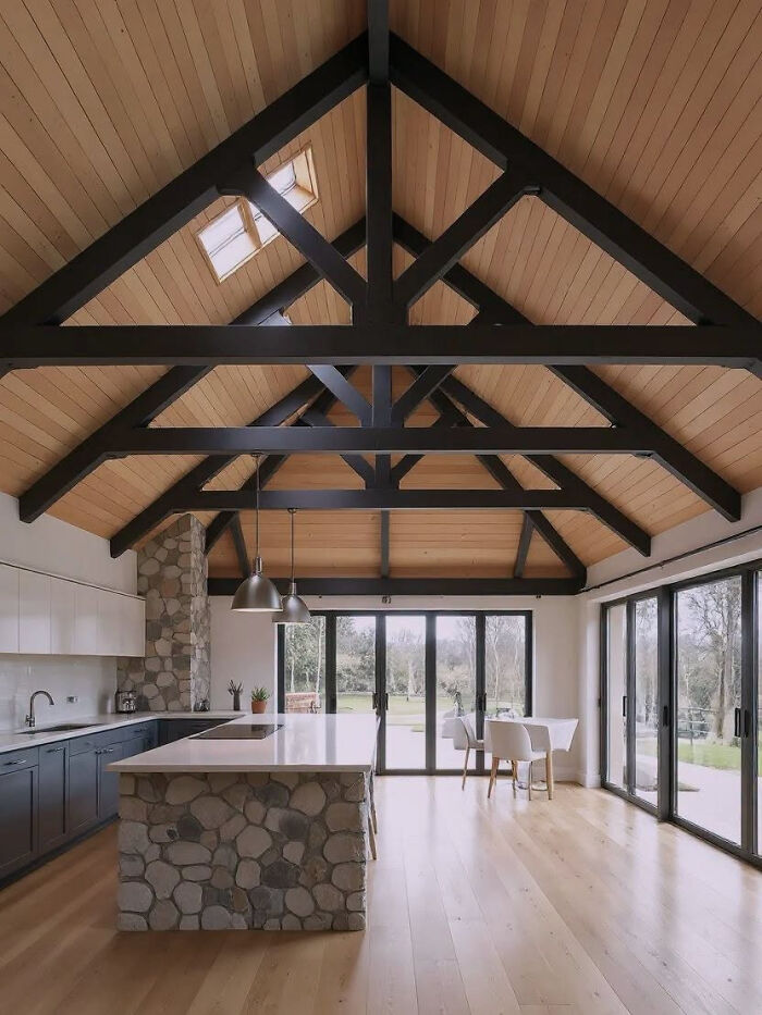 High vaulted ceiling with dark wooden beams, showcasing clever wooden creations