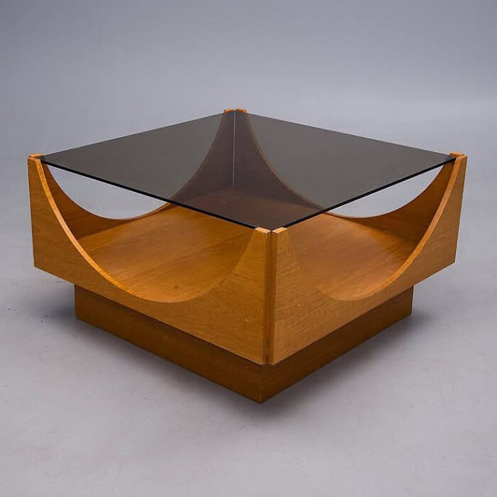 A mid-century modern coffee table made of glass and clever wooden creations.