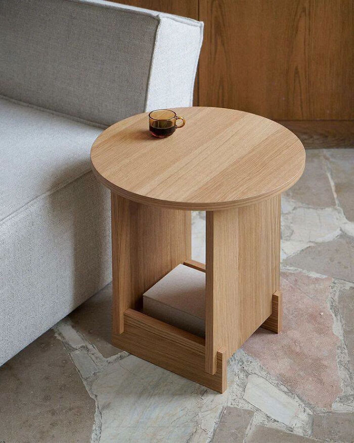 A minimalist round side table made of light-colored wooden creations