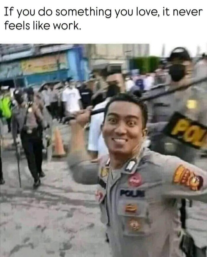 An officer smiling widely during a protest, demonstrating a dark sense of humor in edgy memes.
