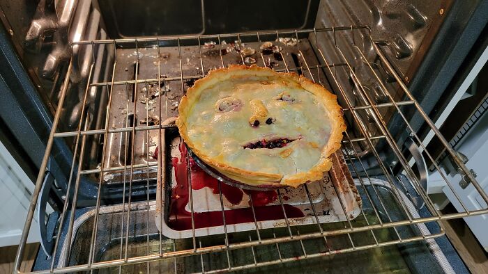 A baked pie with a strange face looking like Halloween didn’t go as planned.