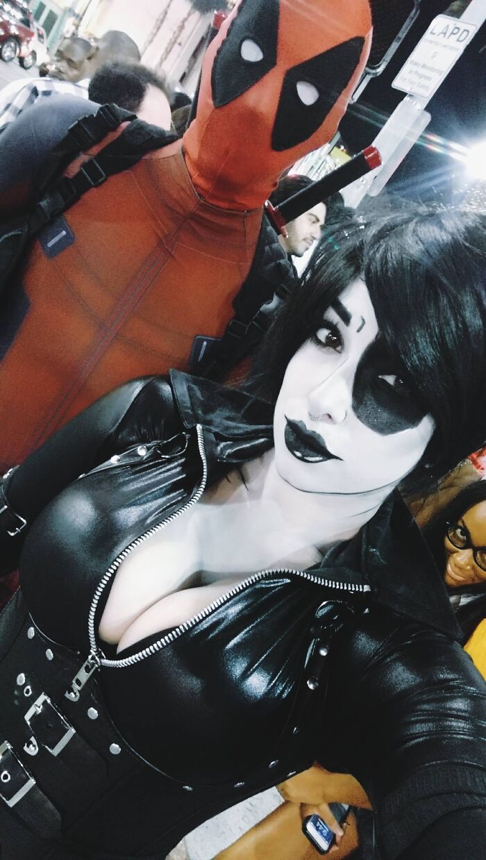 A duo dressed in Deadpool and Domino comic book themed cool Halloween couples costumes taking a selfie