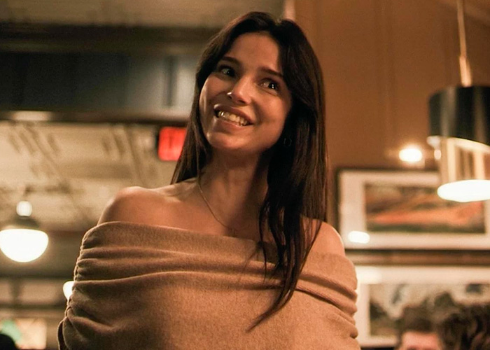 A woman smiling in a scene from the horror hit movie that is at the center of a tasteless award controversy.