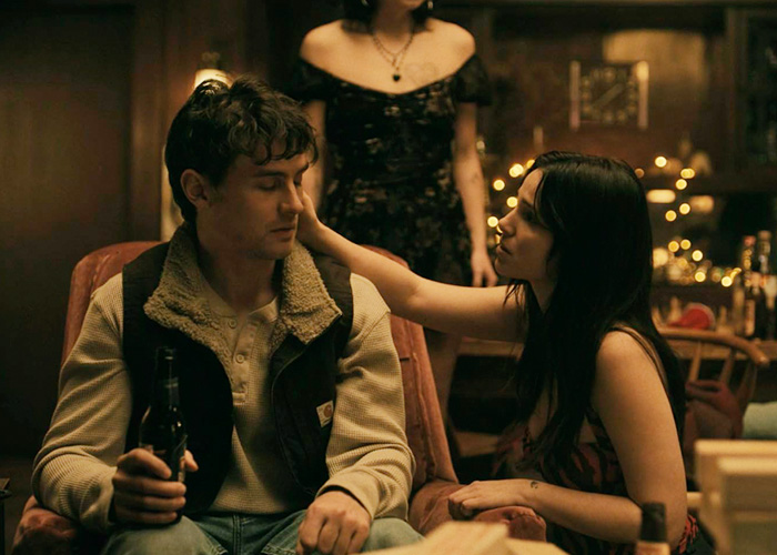 A tense scene from the horror hit film featuring a man and woman interacting in a dimly lit room.
