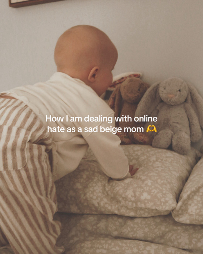 A baby crawling on beige floral pillows near plush toys in a neutral nursery. A baby crawling on beige floral pillows near plush toys in a neutral nursery.