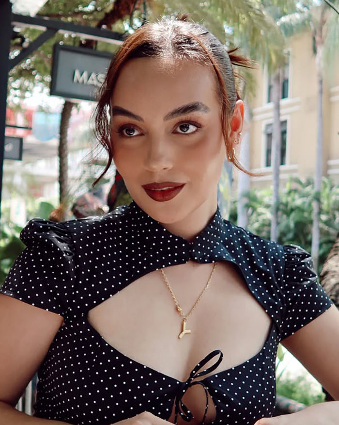 Portrait of a young influencer wearing a polka dot top.
