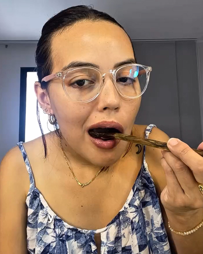 A young influencer eating food with chopsticks before facing sushi health risks