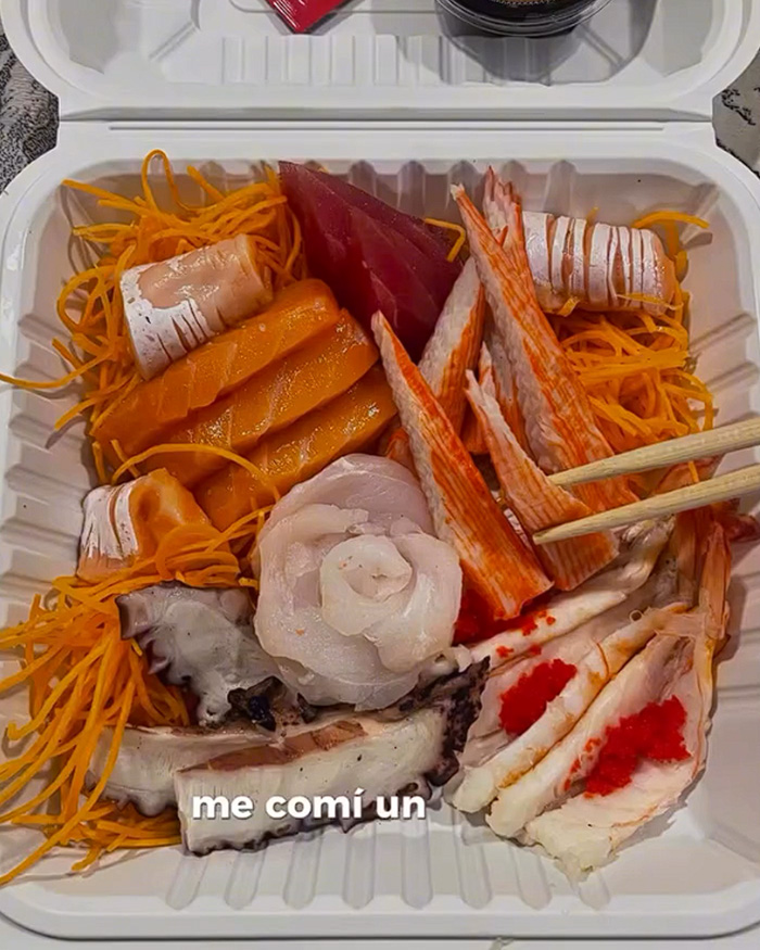 A takeaway container filled with an assortment of raw fish and seafood sushi. A takeaway container filled with an assortment of raw fish and seafood sushi.