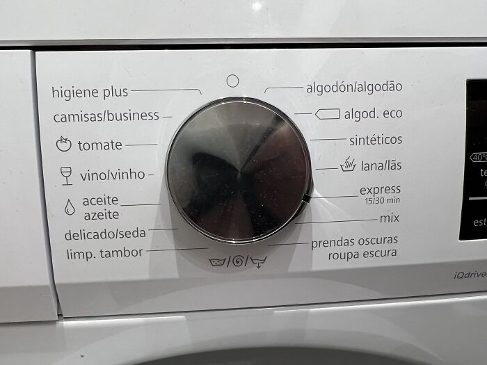 Close-up of a washing machine dial with specific wash cycles written in Spanish, representing useful and ingenious things.