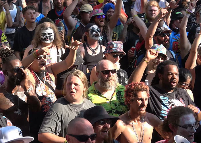 A dense crowd of enthusiastic fans cheering during The Gathering Of The Juggalos