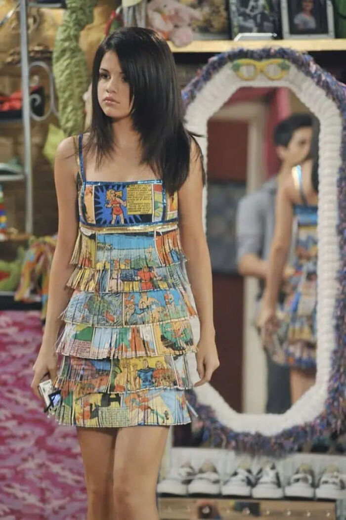 Selena Gomez wearing a comic book dress as iconic movie props on set
