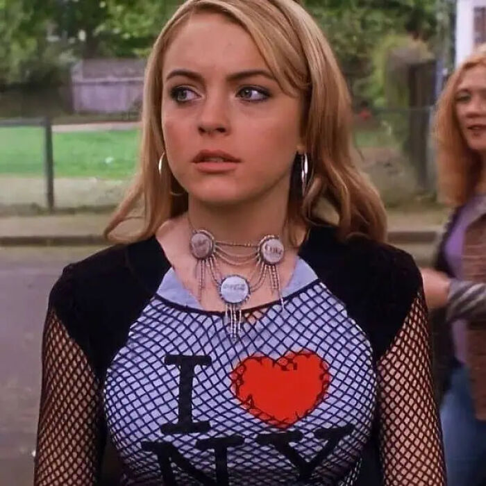 A character wearing a unique bottle cap necklace movie prop in a teen comedy film