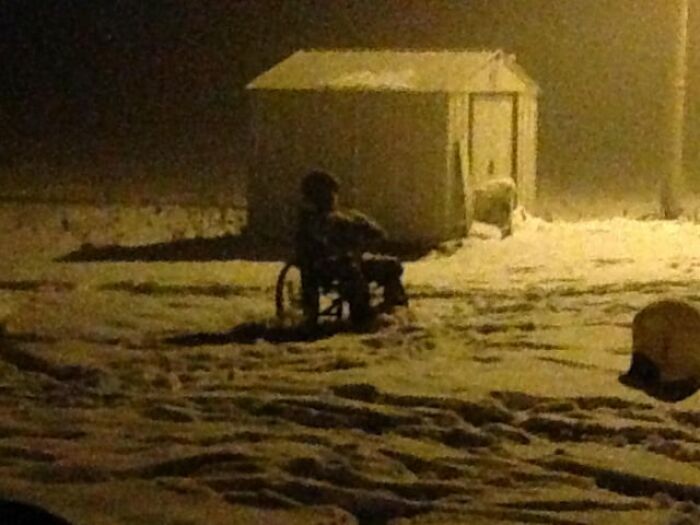 A silhouette of a figure in a wheelchair in snow from creepy photos