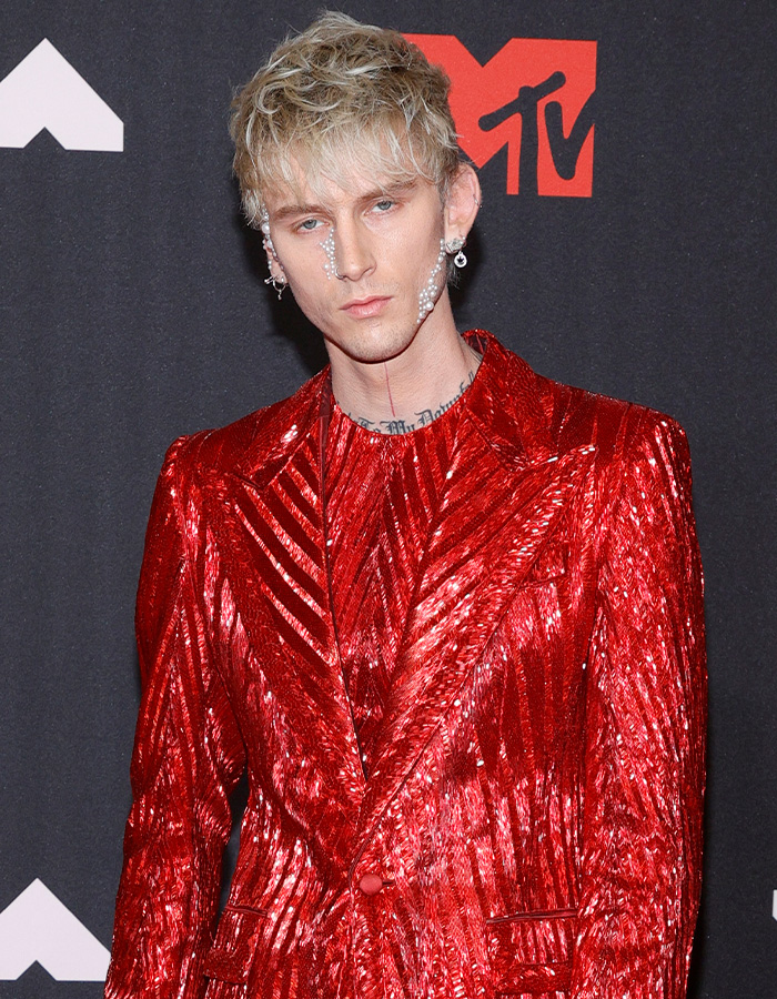 MGK in a shiny red suit with pearl face decoration at MTV event MGK in a shiny red suit with pearl face decoration at MTV event