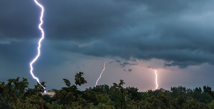 Dramatic lightning bolts strike the ground in a worst-case scenario storm scene.
