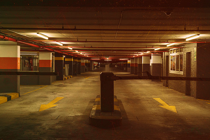 Dimly lit empty parking garage showing a creepy worst-case scenario setting