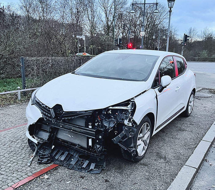 White car with heavily damaged front bumper from an accident worst-case scenario