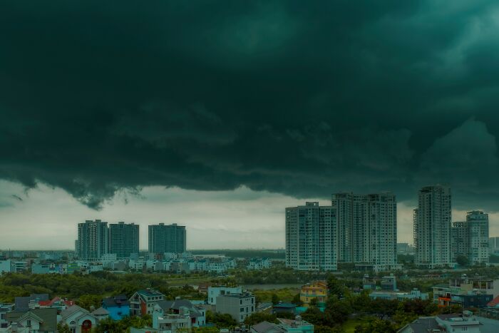 Dark storm clouds over city buildings evoking chilling stories of sensing danger